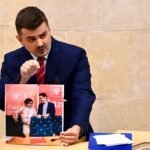 Miguel Ángel Vargas muestra una fotografía de Pedro Casares y María Luisa Real durante una intervención en el Parlamento de Cantabria